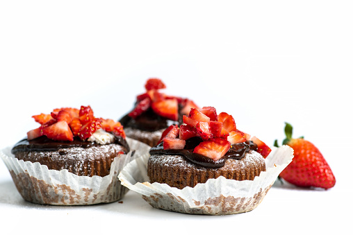Homemade strawberry muffins chocolate brownies on white background with copy space