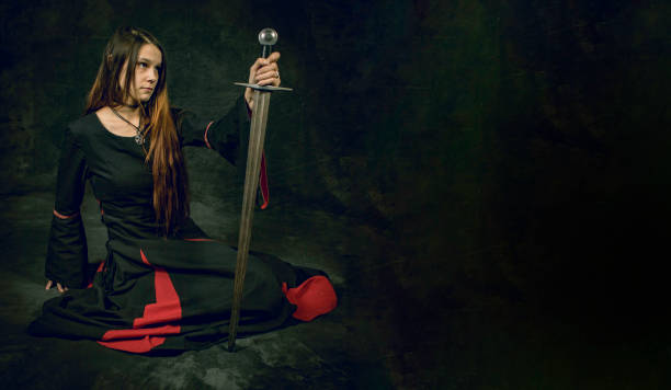 istock woman holding sword 1326240117