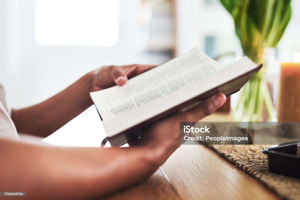 Shot of an unrecognizable female reading the bible These are parts of our calling Bible Stock Photo