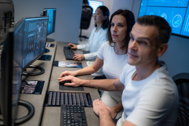 istock Male and female radiologist analysing MRI scans on their computers 1326240179