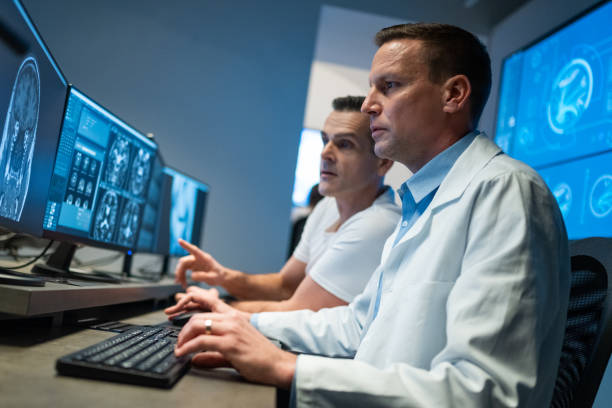 istock Two male radiologists analysing a head MRI scan 1326240287