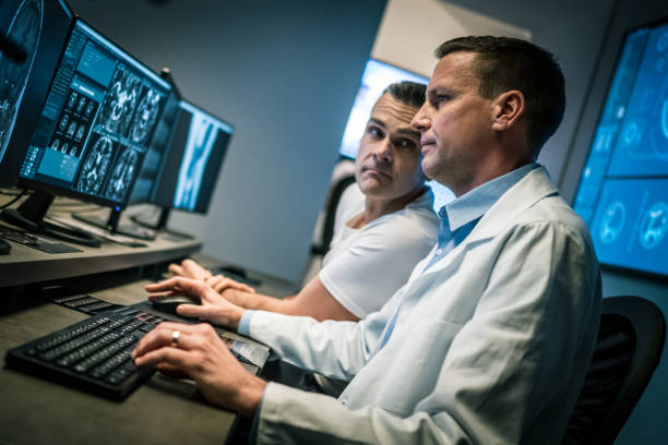 istock Two male radiologists analysing a head MRI scan 1326240374