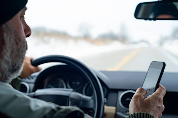 A distracted driver using a phone stock photo