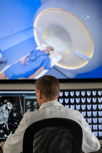istock Male radiologist looking at the MRI scans on the computer 1326240482