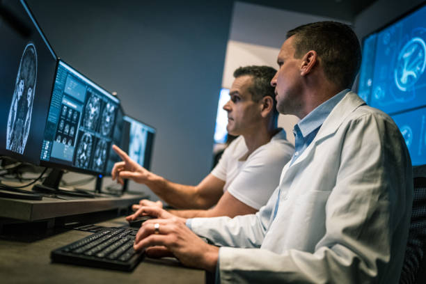 istock Two male radiologists analysing a head MRI scan 1326241055