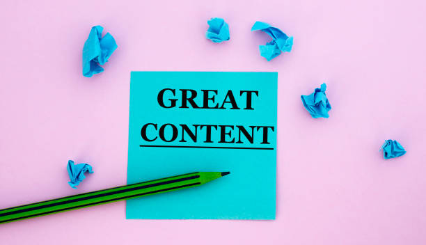 istock GREAT CONTENT - words on a note piece of paper on a pink background with scattered blue crumpled pieces of paper 1326241672