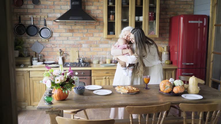 aged lady plays with granddaughter in daughter hugs