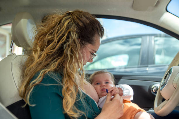 istock Mother breastfeeding in the car 1326243995