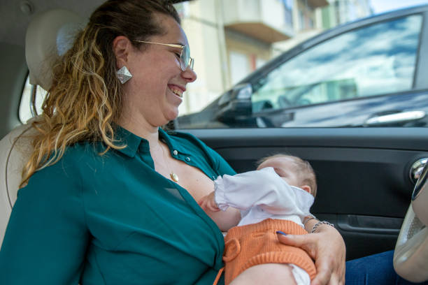 istock Mother breastfeeding in the car 1326244002