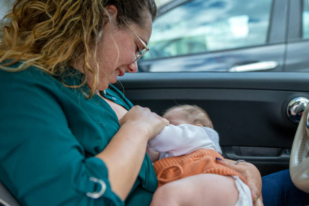 istock Mother breastfeeding in the car 1326244021