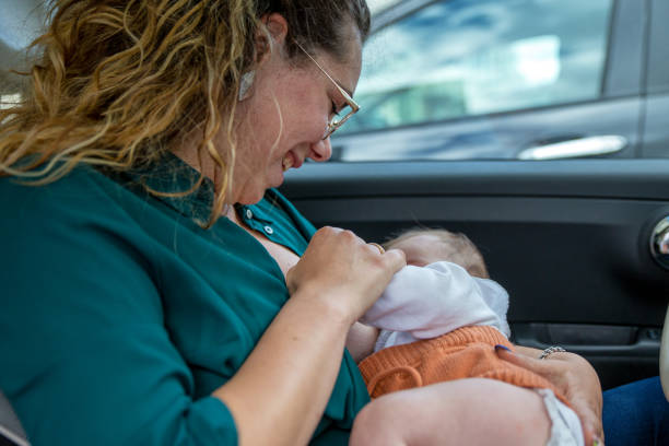istock Mother breastfeeding in the car 1326244024