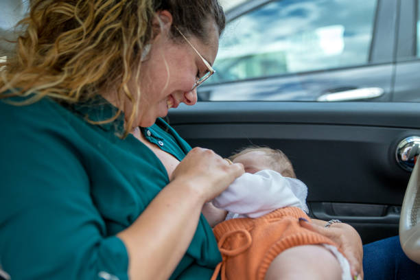 istock Mother breastfeeding in the car 1326244054