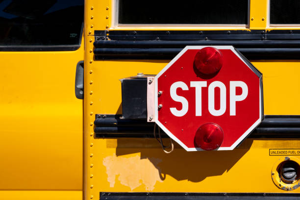 istock Red STOP sign on a yellow school bus 1326249215