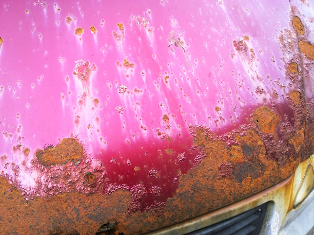 古い赤ワイン色の車のボンネットの板金腐食。錆びた乱雑な表面。道路塩から汚れた食感を損なった。錆の背景。自動車のコンセプトを守る。塗装作業。保険 - rust rusty old rotting ストックフォトと画像