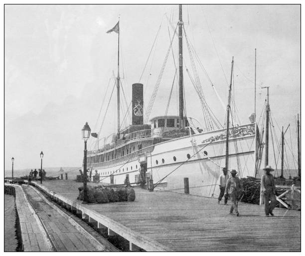 ilustrações, clipart, desenhos animados e ícones de foto antiga em preto e branco: barco a vapor no porto, cienfuegos, cuba - architecture built structure people in the background nautical vessel