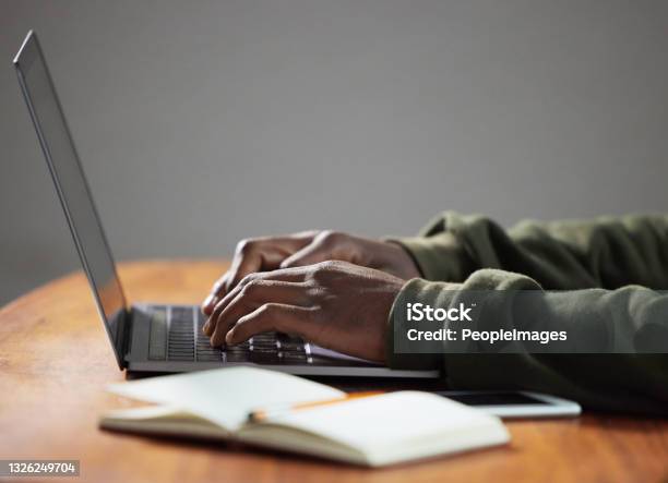 Shot Of An Unrecognizable Person Using A Laptop In An Office Stock Photo - Download Image Now
