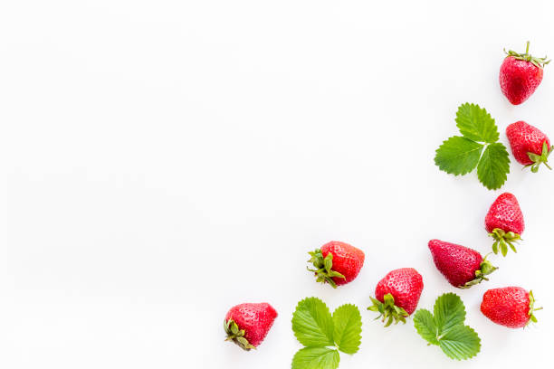istock Red ripe strawberries with green leaves. Top view 1326252098