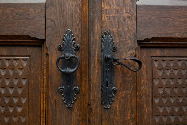 istock Handmade iron door handle on brown decorative wooden door 1326252616