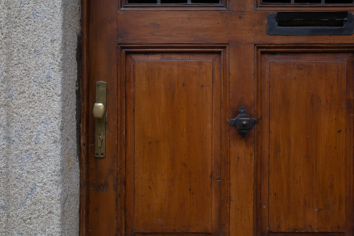 Bronze door knob on an old wooden door. Closeup shot