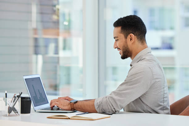 istock Shot of a young businessman using his laptop at work 1326255310