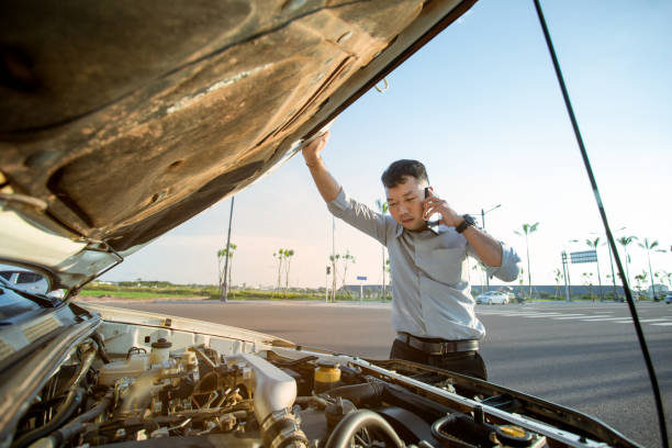 istock Asian man calling for help by a broken car on road 1326255696