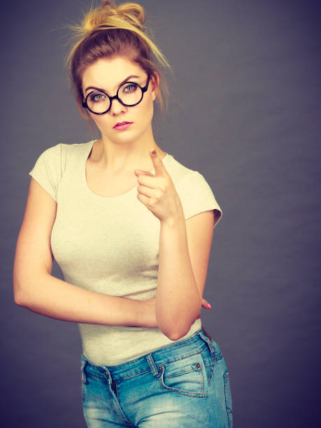 istock Woman wearing eyeglasses pointing at camera 1326255895