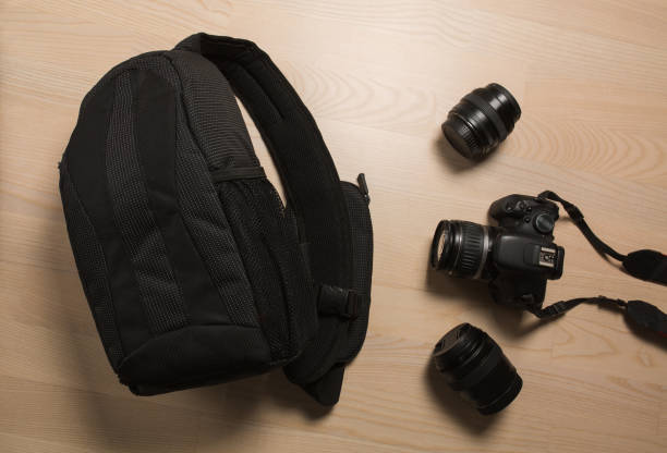 istock Photographer's small backpack with digital slr camera and replaceable lenses 1326257065