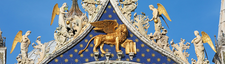 The golden lion with wings, symbol of Saint Mark and Venice, settled over main entrance of Saint Mark Basilica.