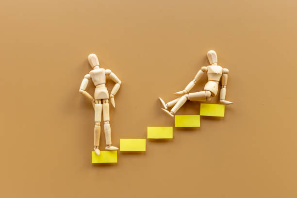 istock Two human mannequin figure on stairs. Helping partner teambuilding leadership concept 1326257410