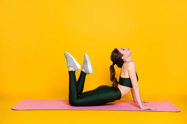 istock Profile side full body view of nice thin slender girl instructor doing everyday shaping isolated on bright yellow color background 1326257450