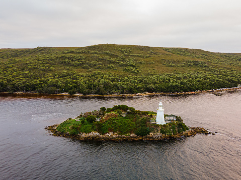 Lighthouse on a small island in Macquarie Harbour Tasmania. “Hell’s Gates”