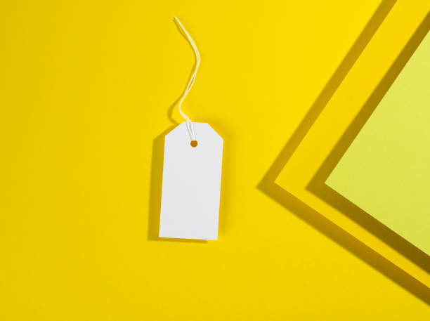 istock blank rectangular paper yellow price tag with white rope on yellow background 1326259675