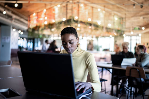 istock Young woman using laptop working at coworking 1326260658