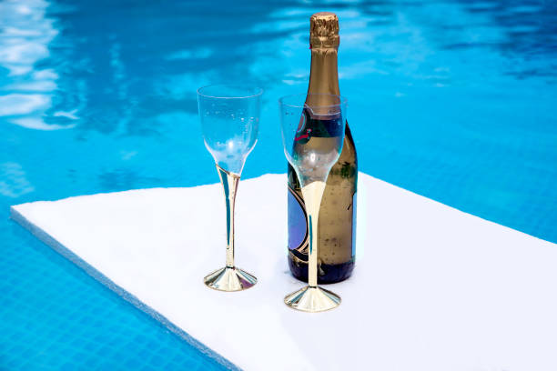 istock Champagne for two in the pool 1326262087