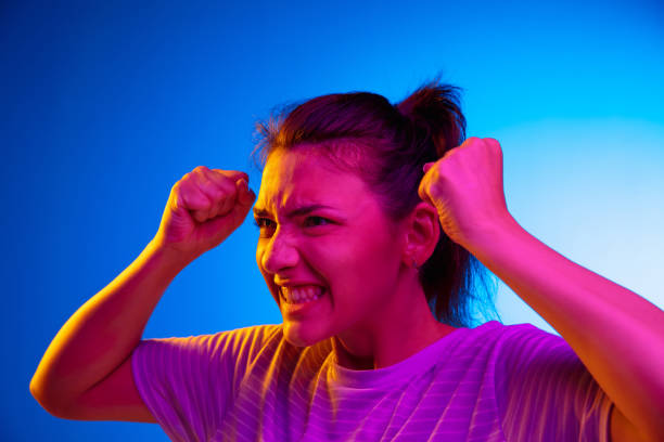 istock Screaming angry. Young caucasian woman's portrait on gradient blue-purple studio background in neon light. Concept of youth, human emotions, facial expression, sales, ad. 1326262924