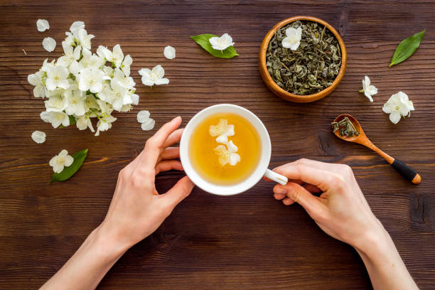 istock Cup of jasmine herbal tea with white flowers. Top view 1326263778