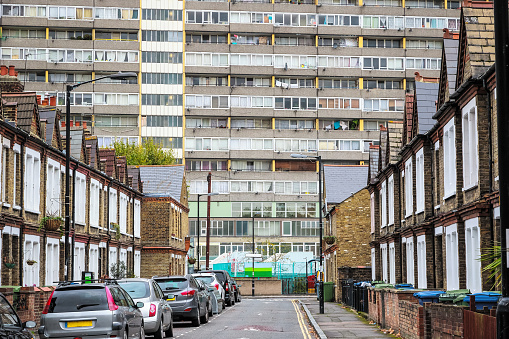 Traditional English terraced houses with huge council block Taplow House of the Aylesbury Estate in the background in south east London
