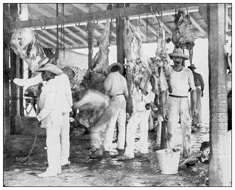 Antique black and white photograph of people from islands in the Caribbean and in the Pacific Ocean; Cuba, Hawaii, Philippines and others: Slaughterhouse, Puerto Rico