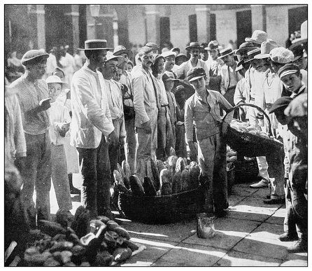 Antique black and white photograph of people from islands in the Caribbean and in the Pacific Ocean; Cuba, Hawaii, Philippines and others: Bread market, San Juan, Puerto Rico