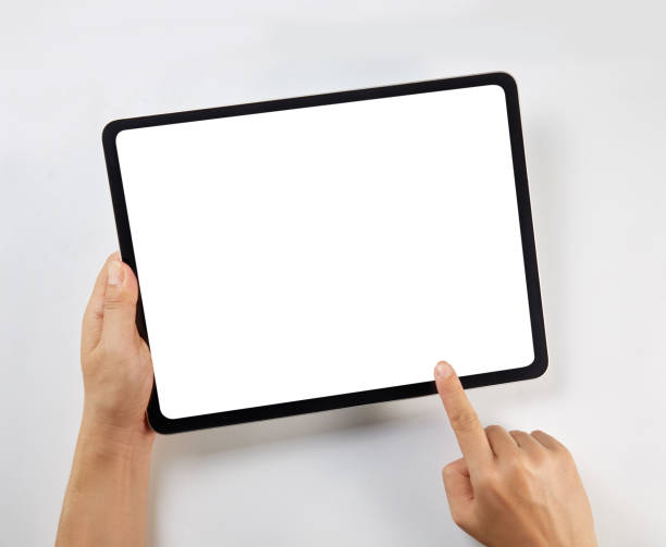 istock Hand holding a mockup tablet with blank screen isolated on white 1326271127