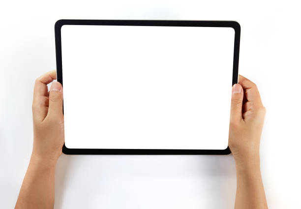istock Hand holding a mockup tablet with blank screen isolated on white 1326271129