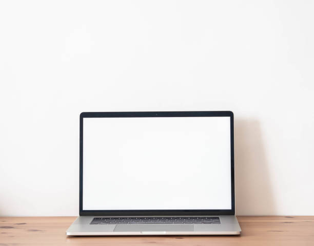 istock Home office wood desk with open laptop with white blank screen for text. 1326272950