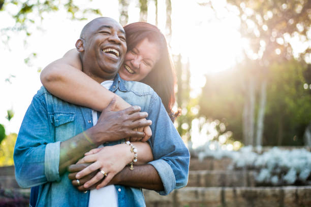 middle aged couple smiling middle aged couple smiling common couple men outdoors stock pictures, royalty-free photos & images