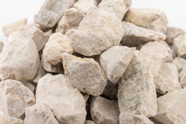 istock Gray small rocks ground texture isolated on white background. Small road stone. 1326275941