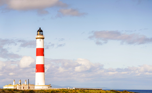 Tarbat Ness Lighthouse in sunny summer weather, located near Tain in Ross County, Scottish Highlands.