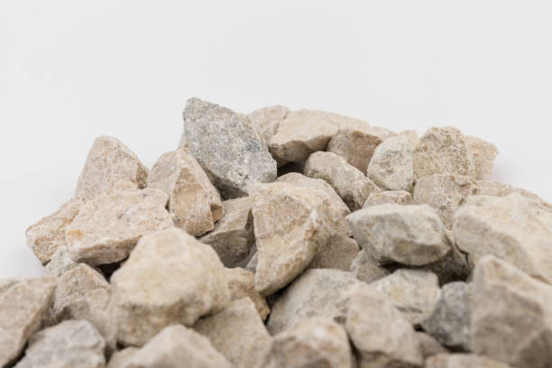 istock Gray small rocks ground texture isolated on white background. Small road stone. 1326277024