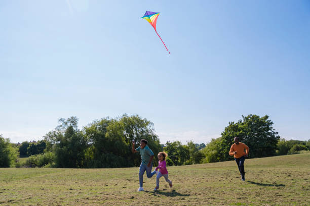 istock Flying a Kite Along the Field 1326278060