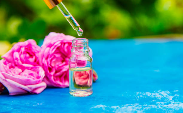 istock tea rose oil in a small bottle. selective focus 1326278286