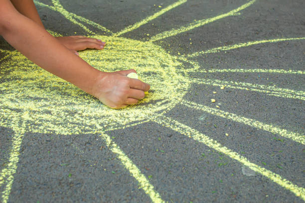 istock child draws with chalk on the pavement. Selective focus.arts 1326278830
