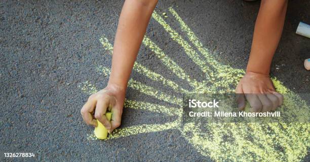 Child Draws With Chalk On The Pavement Selective Focusarts Stock Photo - Download Image Now